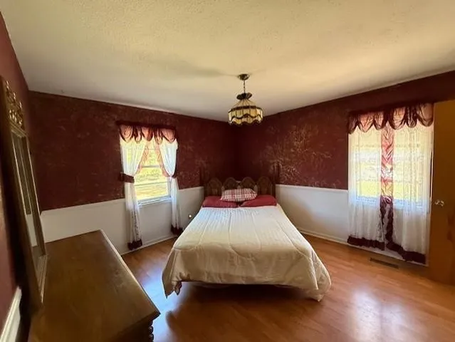 a view of a house with swimming pool and yard