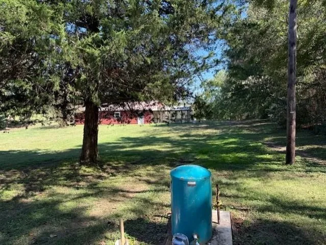 a view of a house with backyard and porch