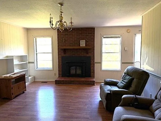 a living room with furniture fireplace and window