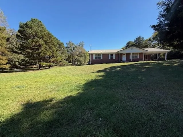 a view of a big yard with a house
