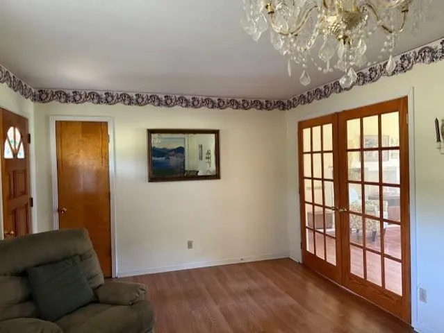 a living room with furniture and a chandelier