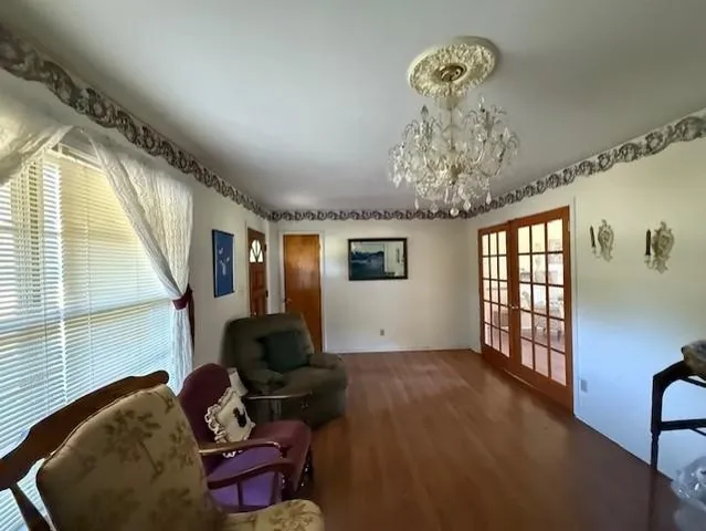 a bedroom with a bed and a chandelier
