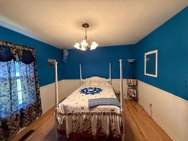 a spacious bedroom with a bed and a window