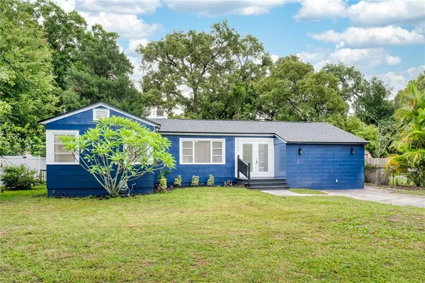 a house that has a big yard with large trees