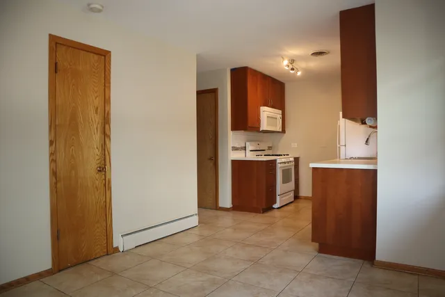 a kitchen with a refrigerator and a stove