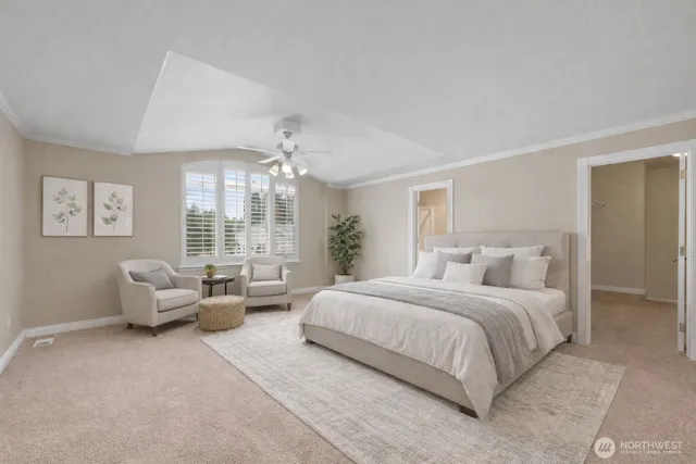 a spacious bedroom with a bed and glass windows