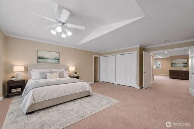 a bedroom with a large bed and a chandelier