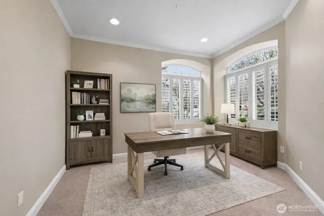a view of a workspace with furniture and a window