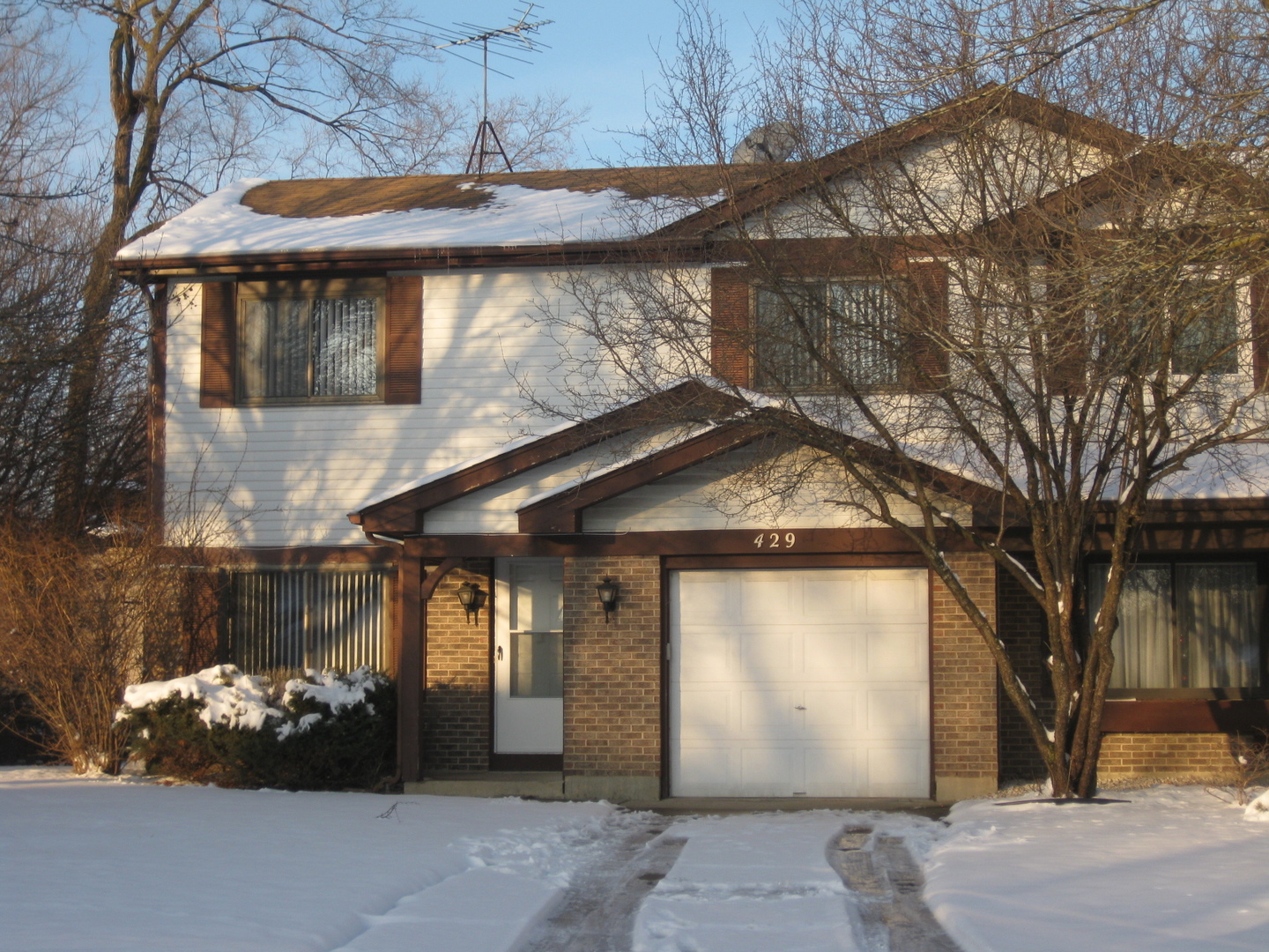 429 Pacific Court Wheeling, IL 60090 - Photo 1 of 16 a front view of a house with a yard