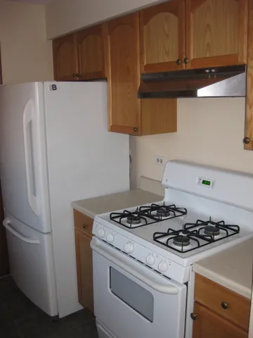 a kitchen with a stove and a refrigerator