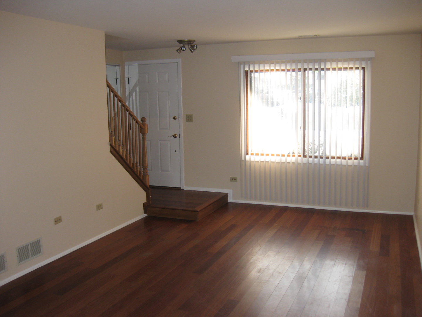 429 Pacific Court Wheeling, IL 60090 - Photo 5 of 16 an empty room with wooden floor and windows
