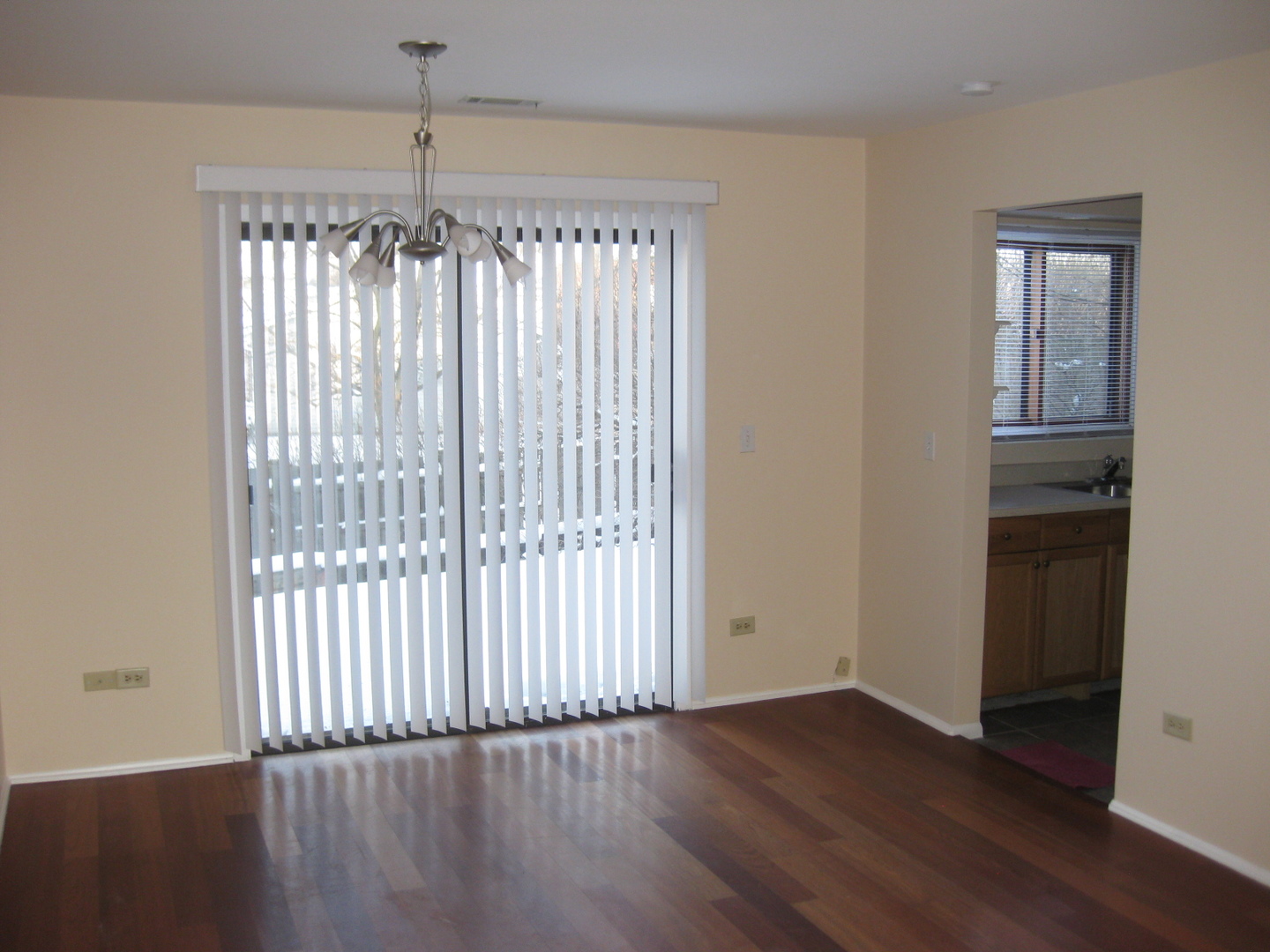 429 Pacific Court Wheeling, IL 60090 - Photo 7 of 16 an empty room with wooden floor and windows
