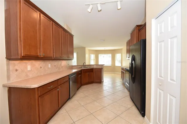 a large kitchen with a sink and cabinets