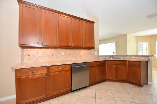 a kitchen with stainless steel appliances granite countertop a sink and cabinets