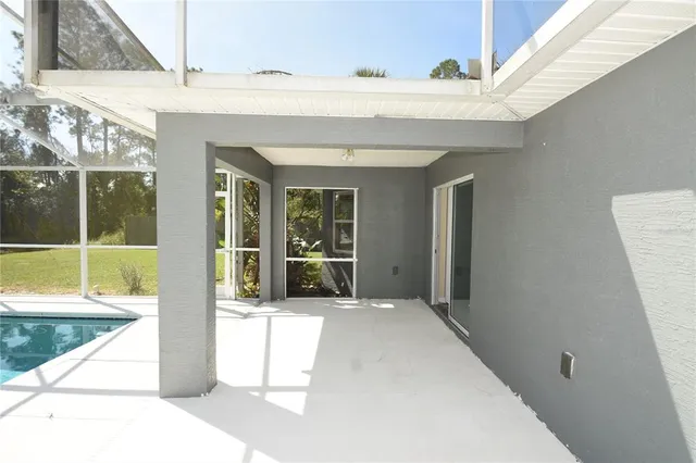 a view of a patio with table and chairs