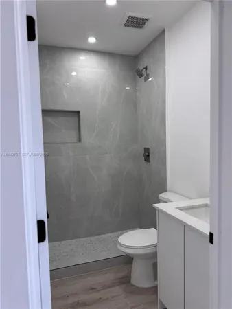 a bathroom with a toilet a sink and shower