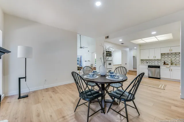 a view of a dining room with furniture and wooden floor