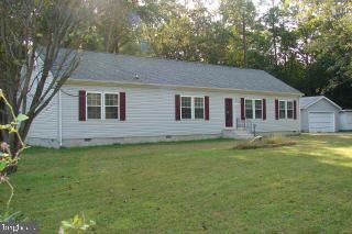 31629 Melson Road Delmar, MD 21875 - Photo 1 of 12 a backyard of a house with yard table and chairs