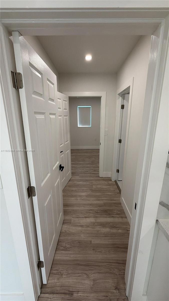 935 Jefferson Avenue, Unit 10 Miami Beach, FL 33139 - Photo 11 of 11 a view of a hallway with wooden floor and staircase