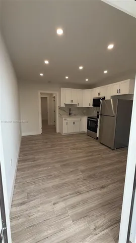 a view of kitchen with wooden floor