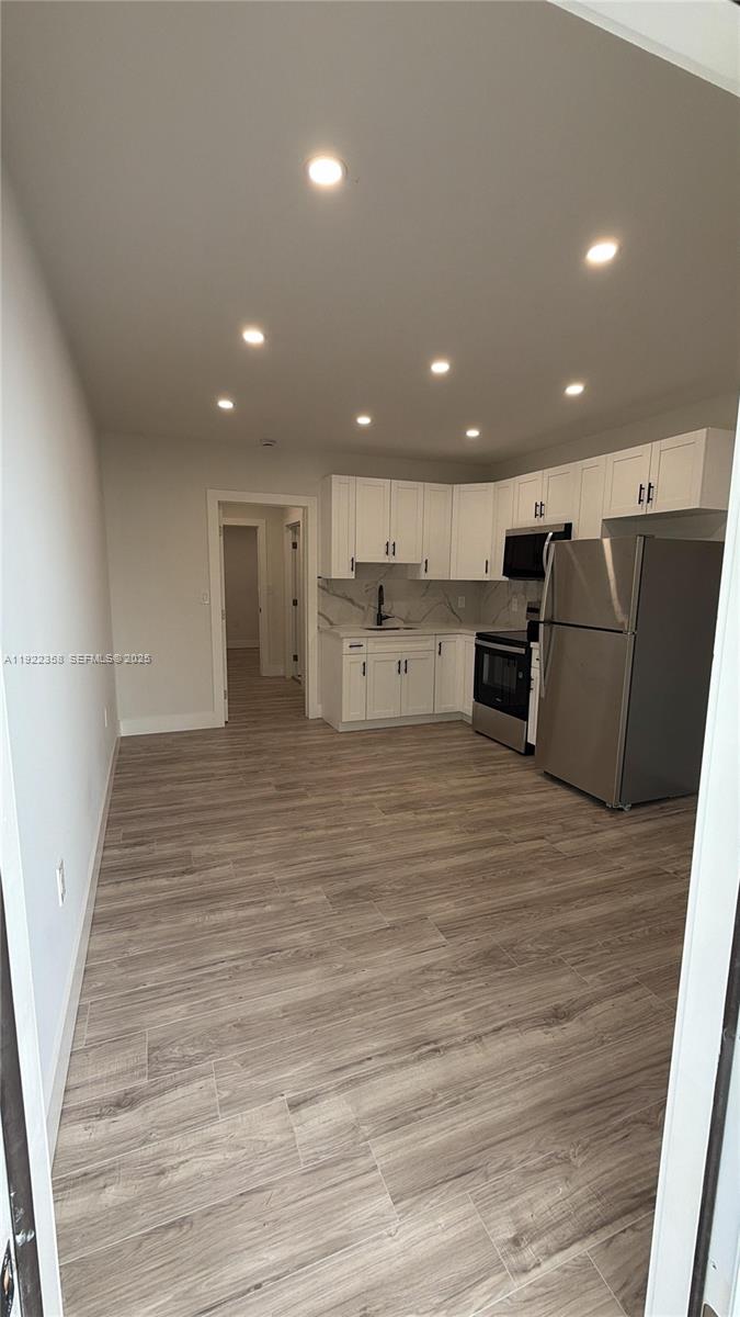 935 Jefferson Avenue, Unit 10 Miami Beach, FL 33139 - Photo 2 of 11 a view of kitchen with wooden floor