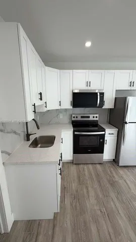 a kitchen with wooden cabinets and white appliances
