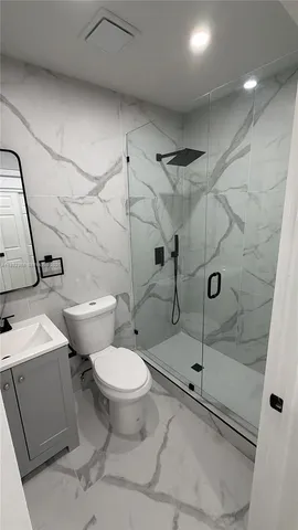 a bathroom with a toilet sink and shower