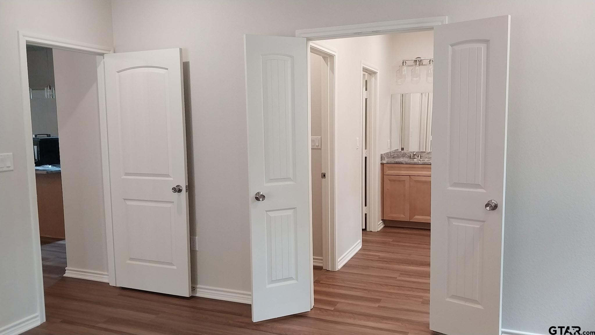 1262 George Richey Road Gladewater, TX 75647 - Photo 7 of 22 a view of a hallway with wooden floor