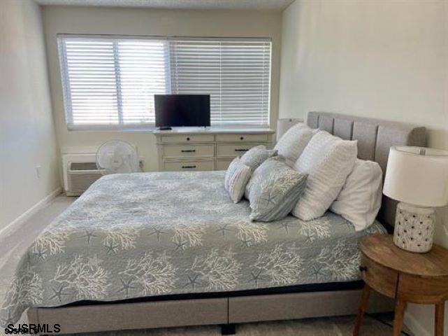 4500 West Brigantine Avenue, Unit 1314 Brigantine, NJ 08203 - Photo 8 of 11 a bedroom with a bed window and a flat screen tv