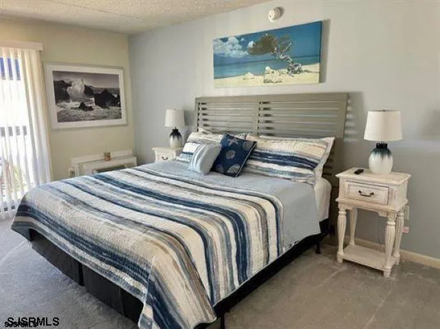 a bedroom with a bed and night stand