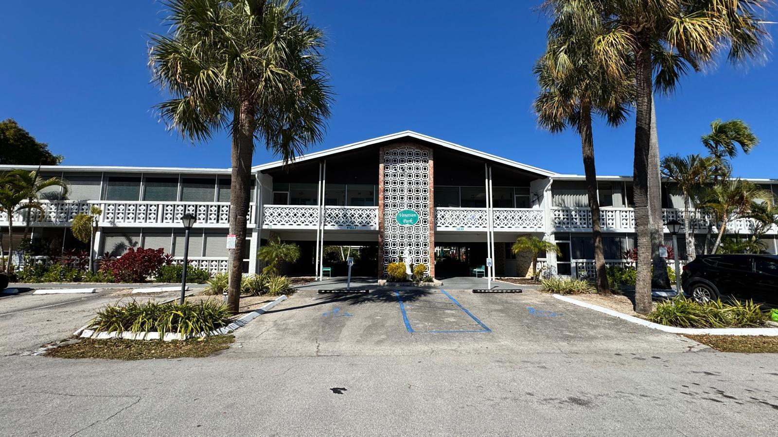 2151 Northeast 42nd Court, Unit 221 Lighthouse Point, FL 33064 - Photo 1 of 31 a front view of a building with palm trees