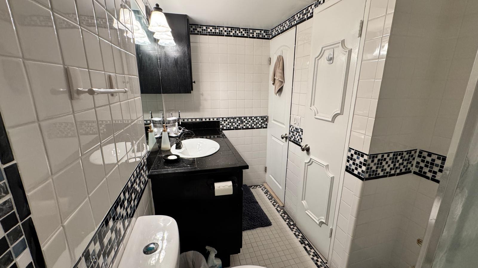 2151 Northeast 42nd Court, Unit 221 Lighthouse Point, FL 33064 - Photo 12 of 31 a bathroom with a sink and a mirror
