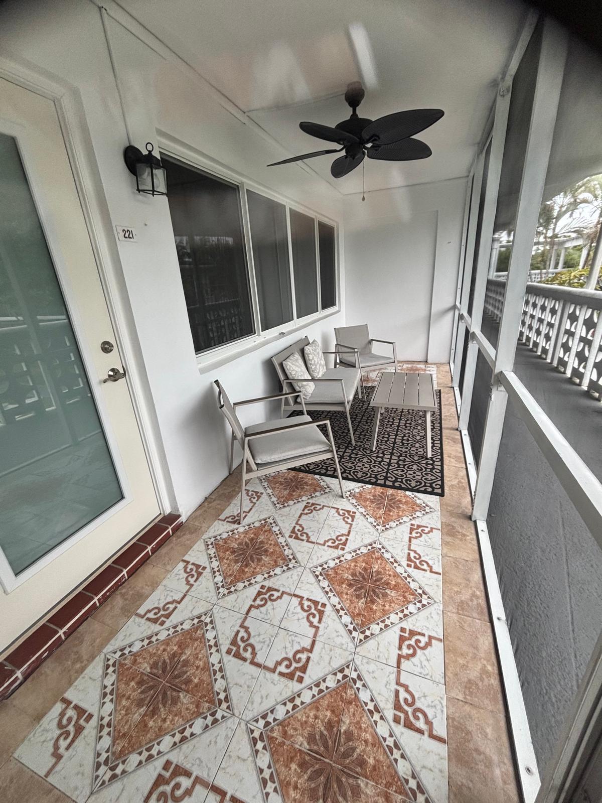 2151 Northeast 42nd Court, Unit 221 Lighthouse Point, FL 33064 - Photo 18 of 31 a living room with furniture