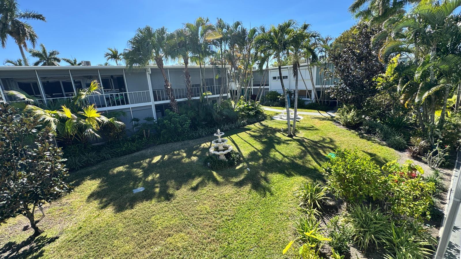 2151 Northeast 42nd Court, Unit 221 Lighthouse Point, FL 33064 - Photo 23 of 31 a view of yard with swimming pool and green space