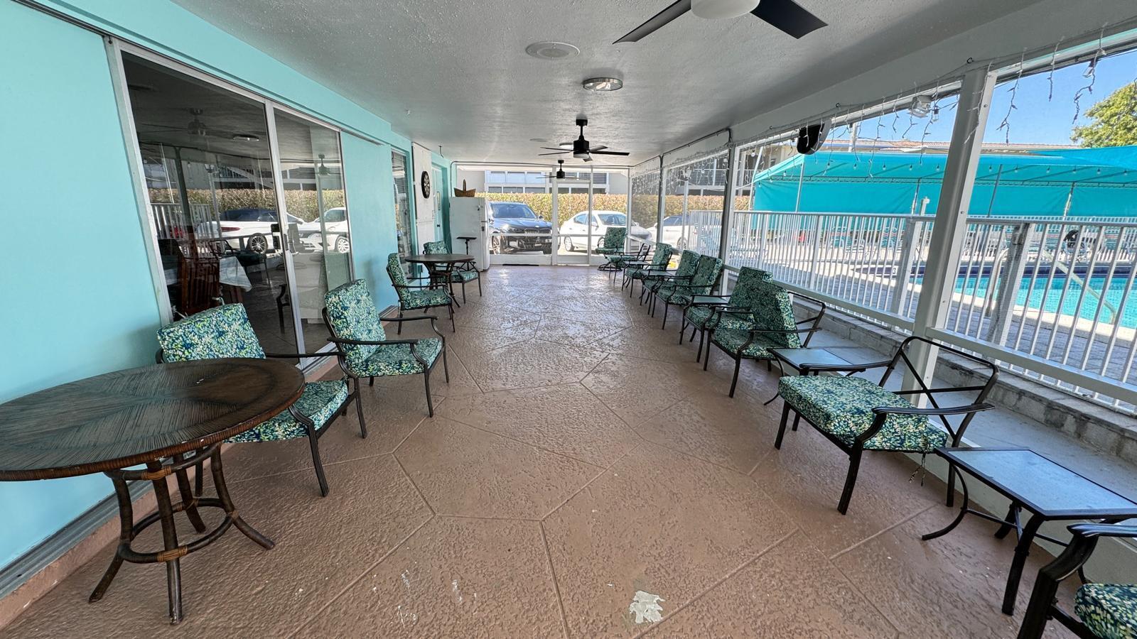 2151 Northeast 42nd Court, Unit 221 Lighthouse Point, FL 33064 - Photo 26 of 31 a lobby with furniture and a floor to ceiling window