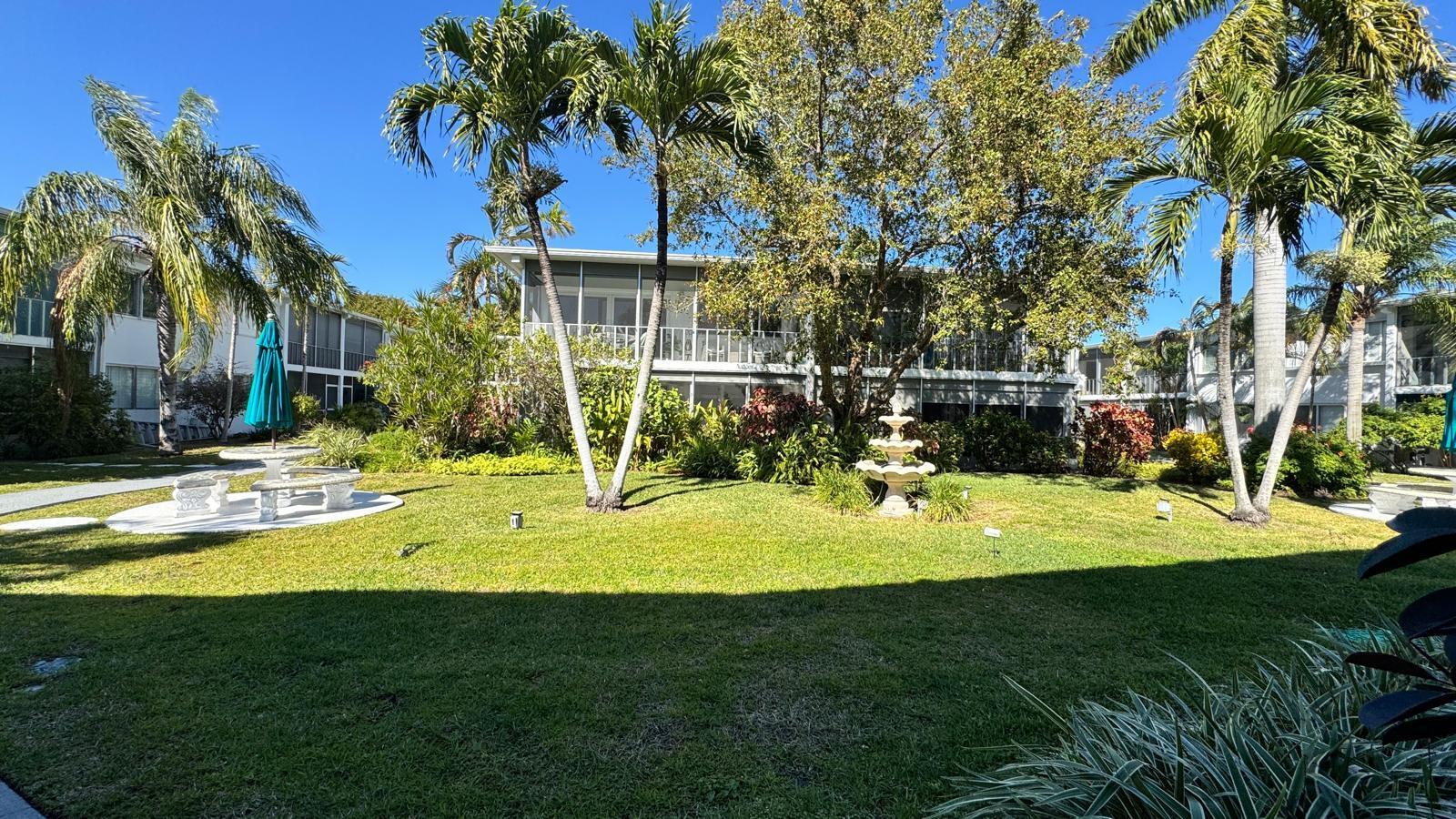 2151 Northeast 42nd Court, Unit 221 Lighthouse Point, FL 33064 - Photo 30 of 31 a view of a patio with a table and chairs