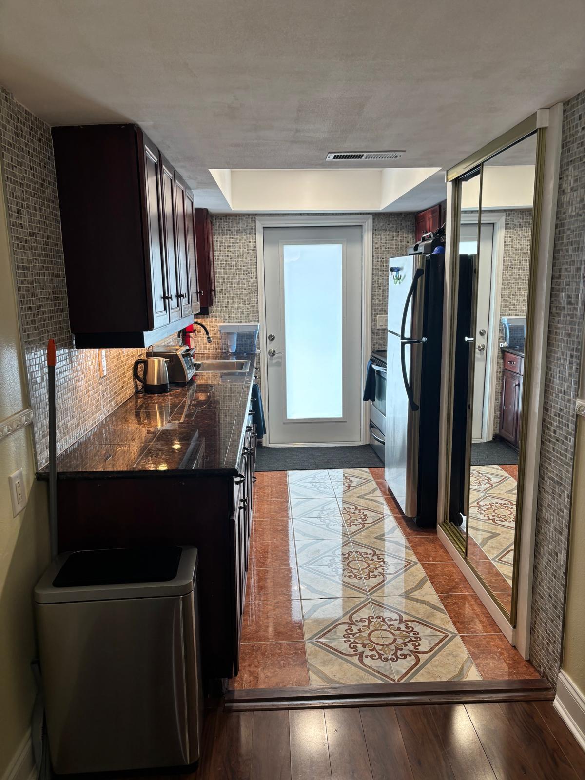 2151 Northeast 42nd Court, Unit 221 Lighthouse Point, FL 33064 - Photo 5 of 31 a kitchen with a refrigerator and a sink