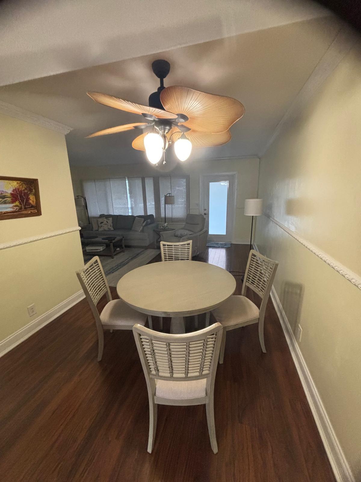 2151 Northeast 42nd Court, Unit 221 Lighthouse Point, FL 33064 - Photo 6 of 31 a dining room with a wooden table and chairs