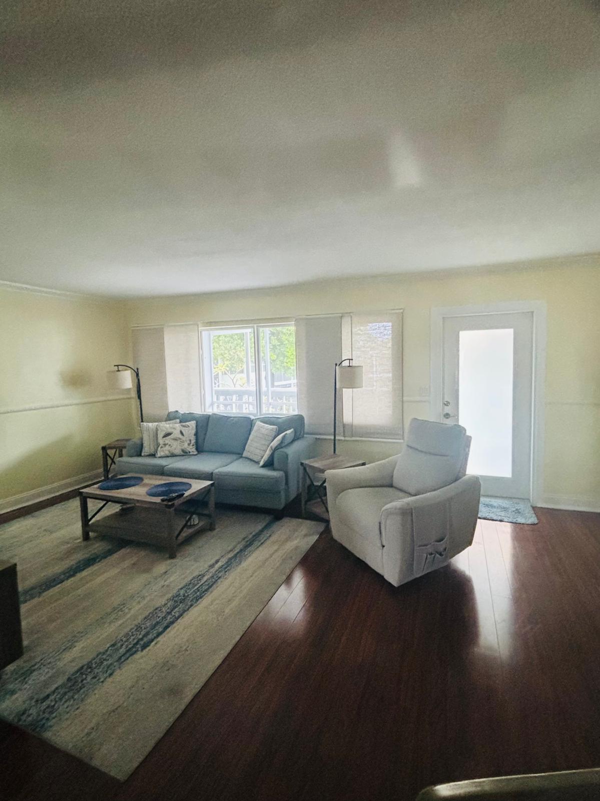 2151 Northeast 42nd Court, Unit 221 Lighthouse Point, FL 33064 - Photo 7 of 31 a living room with furniture and a wooden floor