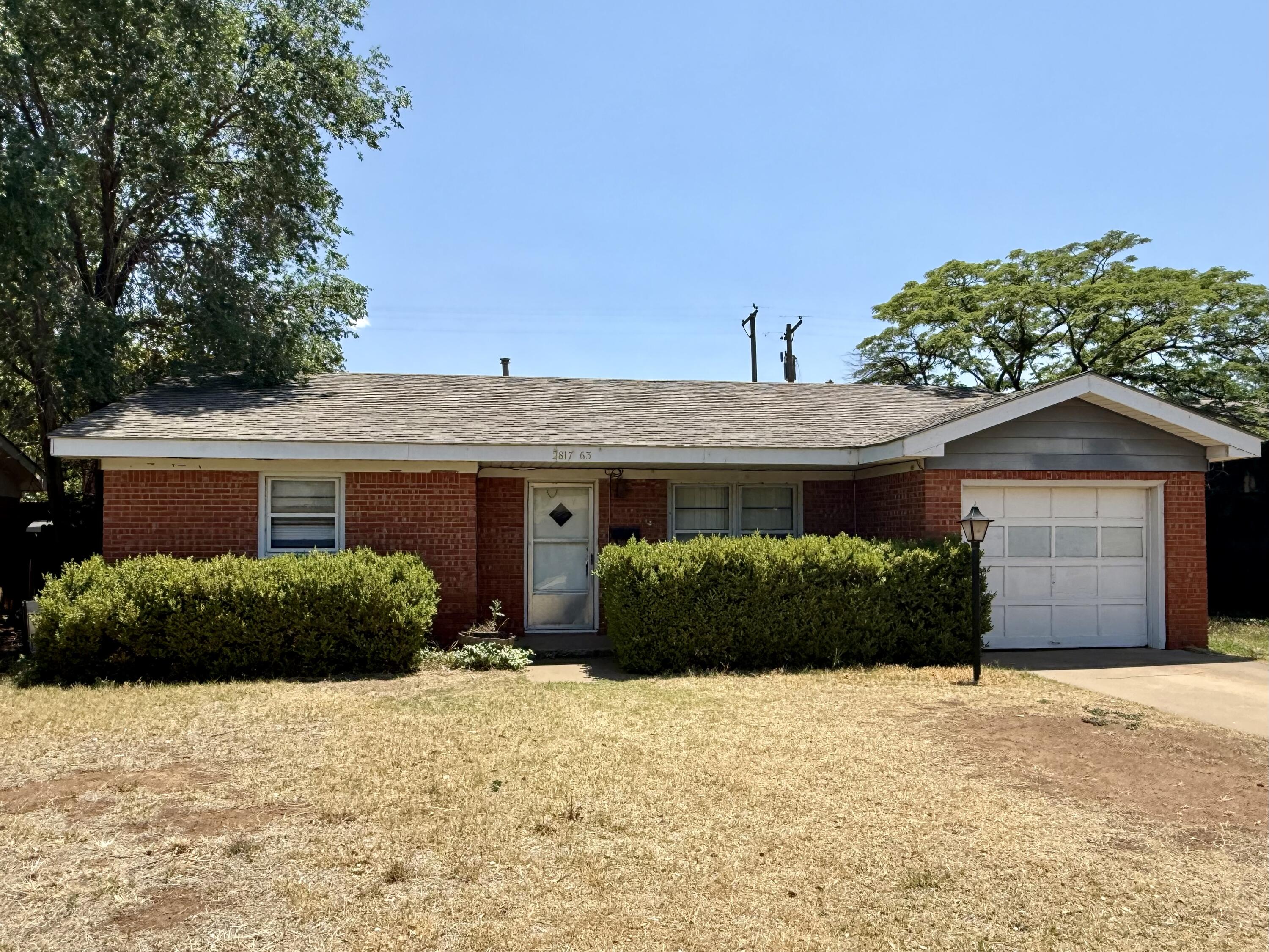 2817 63rd Street Lubbock, TX 79413 - Photo 1 of 16 a front view of a house with a yard