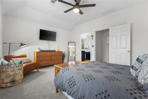 a bedroom with bed and flat screen tv