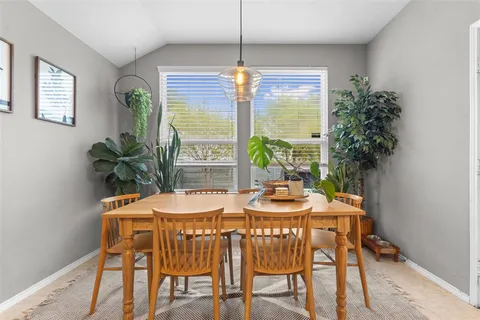 a kitchen with a stove a refrigerator and a dining table