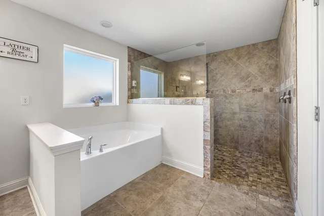 a bathroom with a bathtub sink and mirror