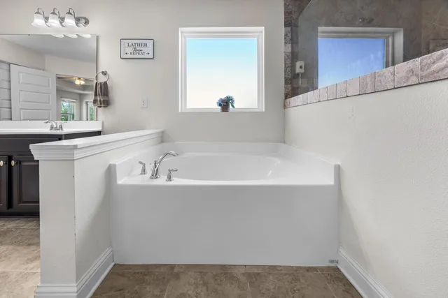 a bathroom with a bathtub and a sink