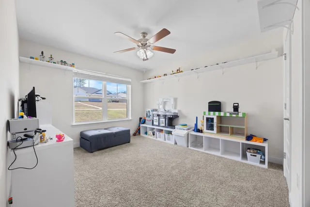 a view of a workspace with furniture and a book shelf