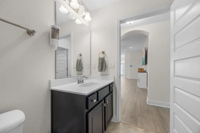 a bedroom with a bed and a ceiling fan