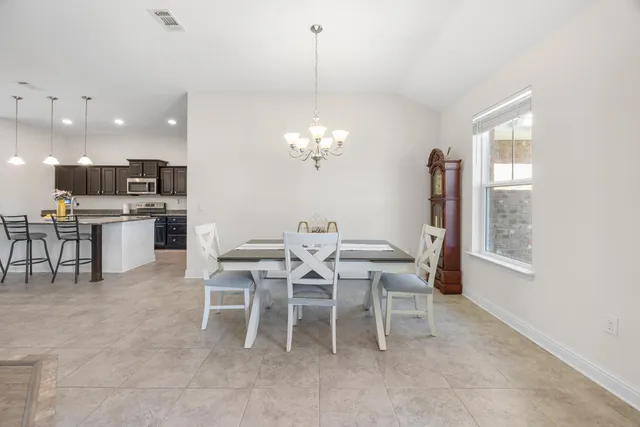 a dining room with furniture and window