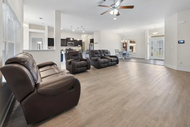 a living room with furniture and kitchen view