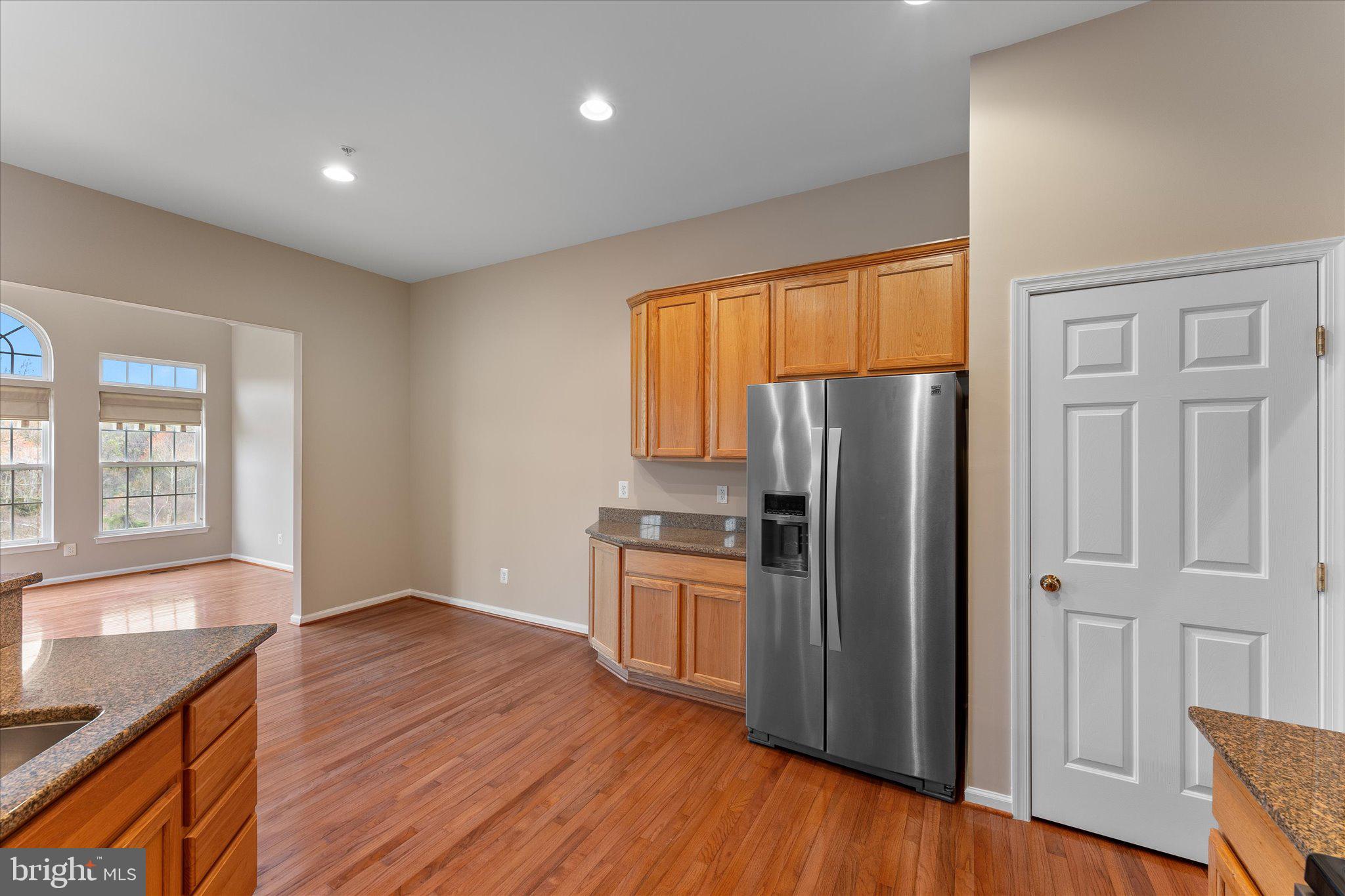 6696 Stream View Lane Warrenton, VA 20187 - Photo 12 of 57 a kitchen with stainless steel appliances granite countertop a refrigerator a sink and wooden cabinets
