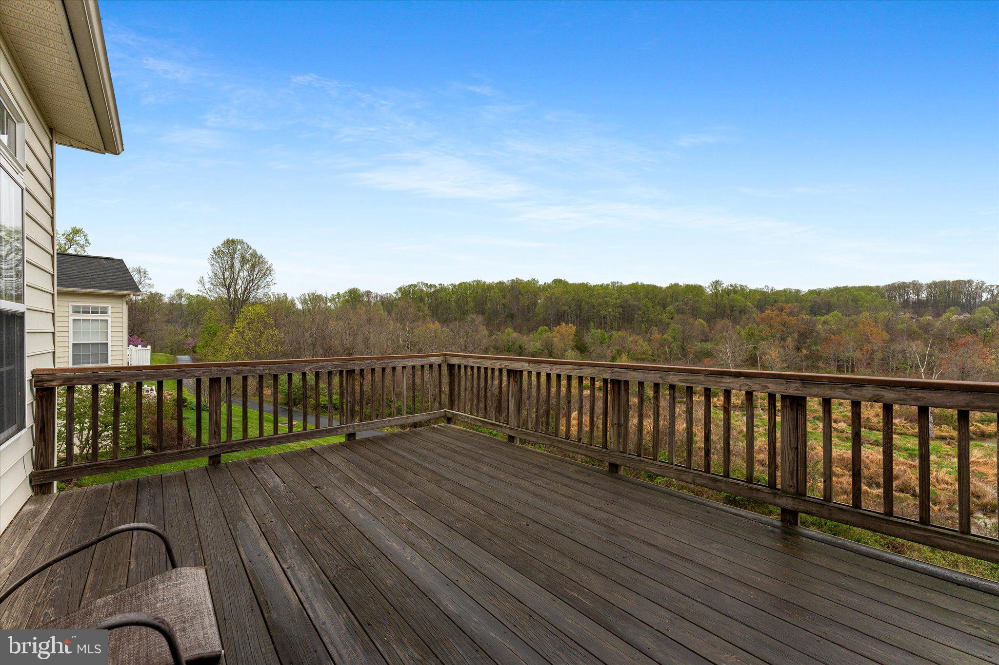 6696 Stream View Lane Warrenton, VA 20187 - Photo 16 of 57 a balcony with wooden floor and fence